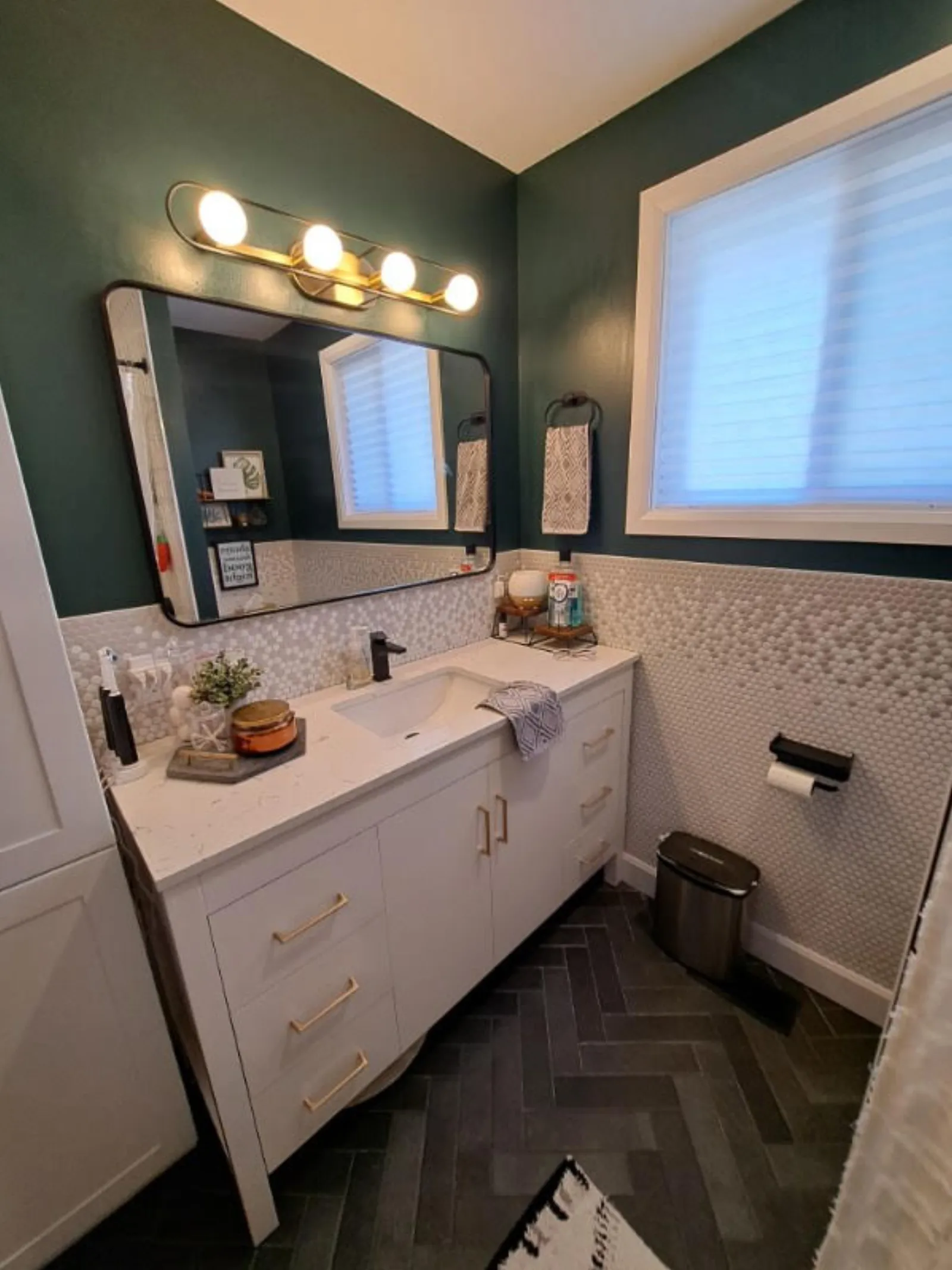 Custom bathroom remodel with floating vanity and herringbone tile by Action Construction North Bay