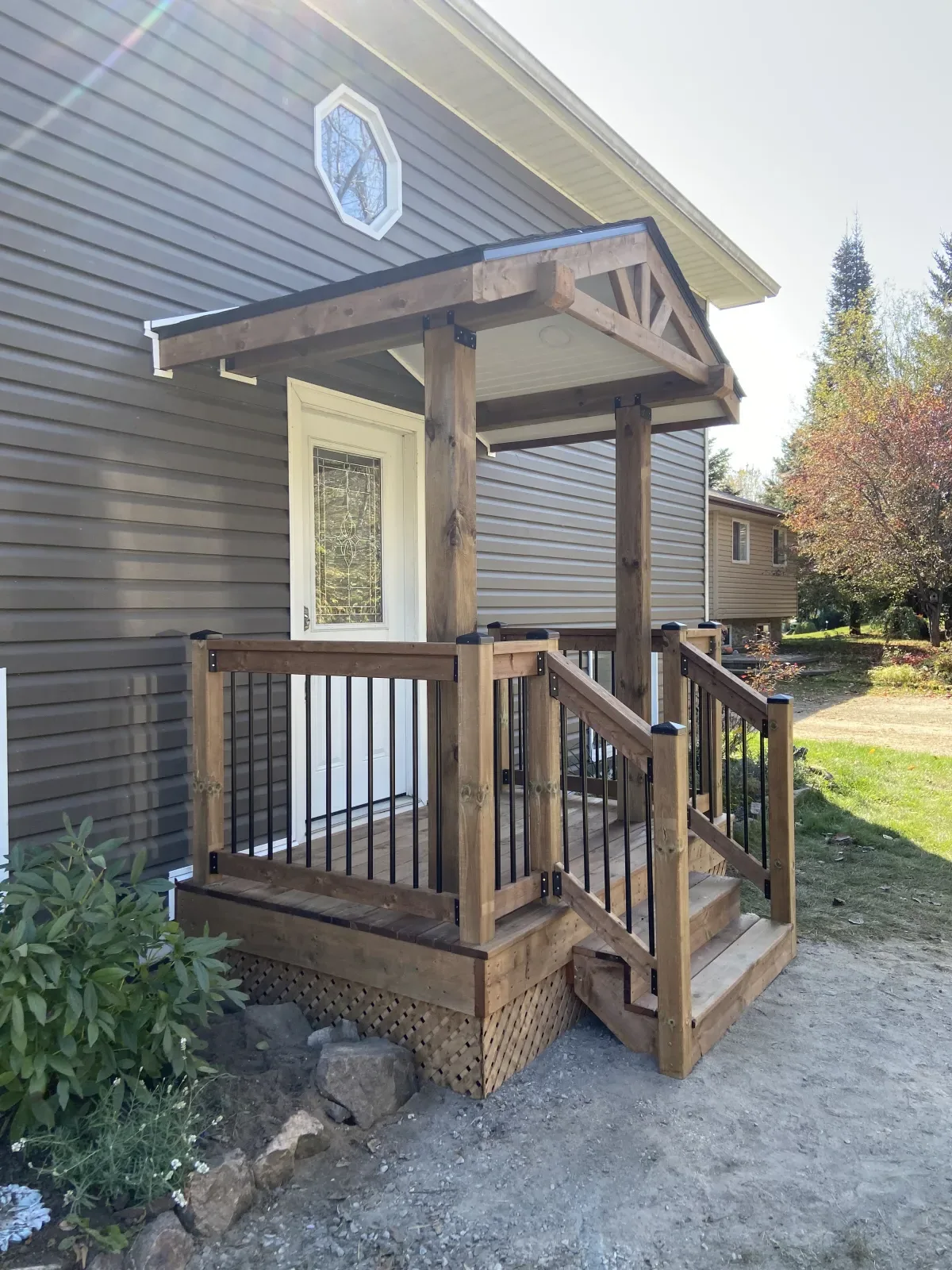 Custom composite deck with glass railing and pergola built by Action Construction in North Bay