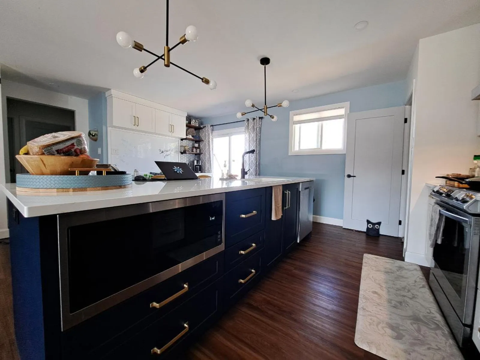 Navy island kitchen with brass hardware in North Bay